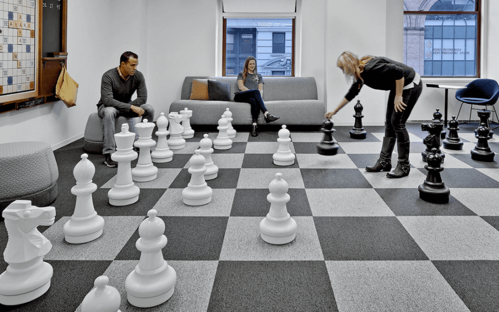 Office workers playing floor chess
