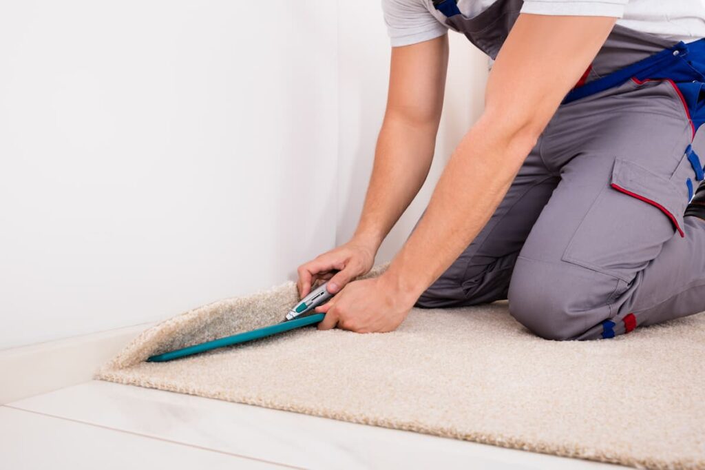 Carpet Installer Cutting Carpet